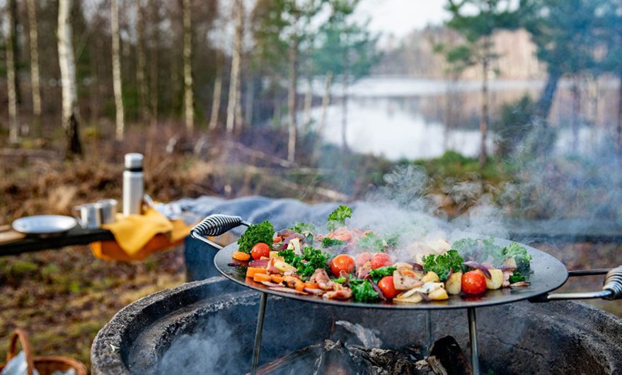 En wokpanna över en eld vid grillplats bredvid Eseredssjön i Ätran.